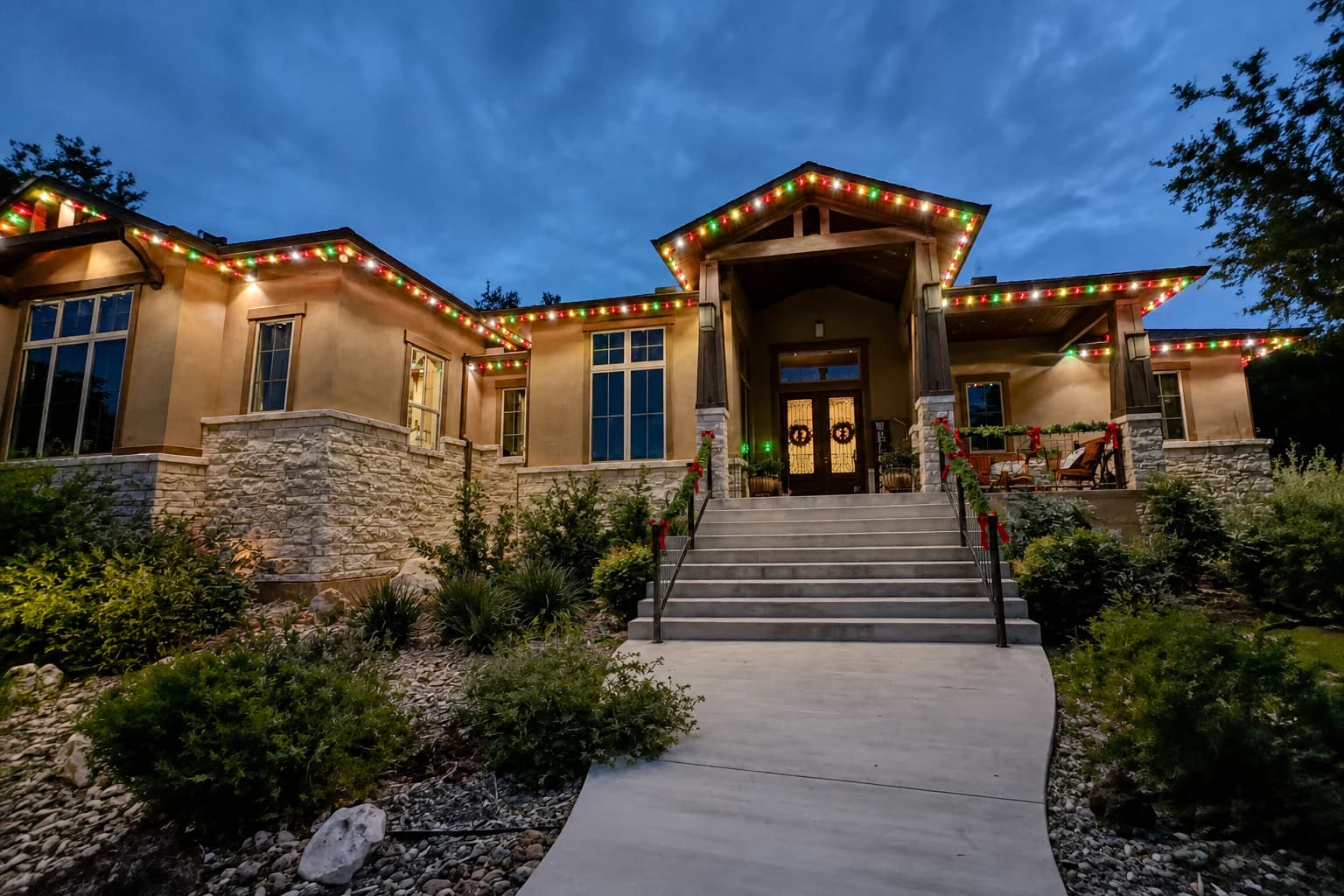 Customer-supplied LIT365 installation with permanent multicolor soffit lighting tracing a home's roofline at dusk