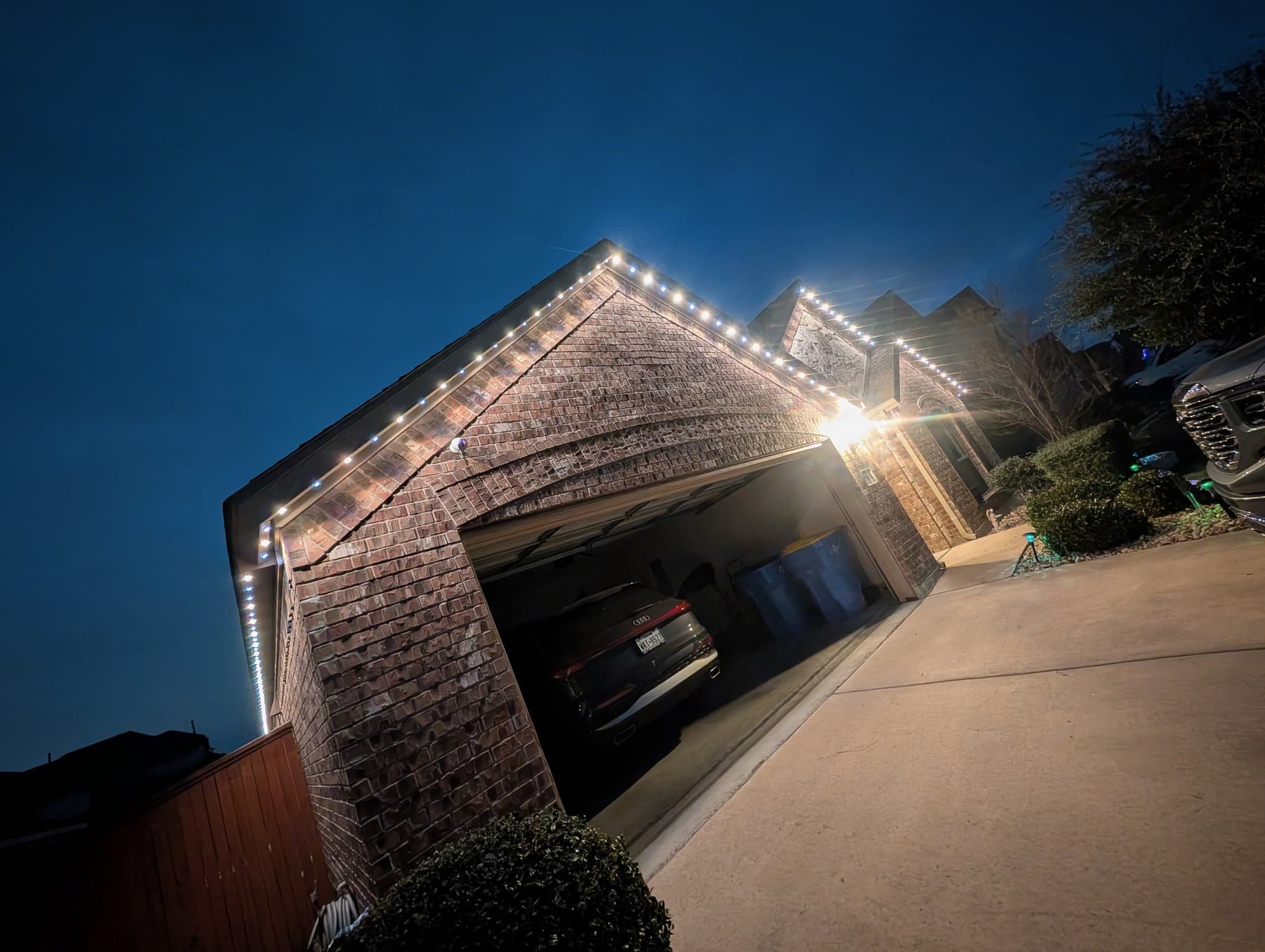 Customer-supplied LIT365 installation showing illuminated garage gables and rooflines at night