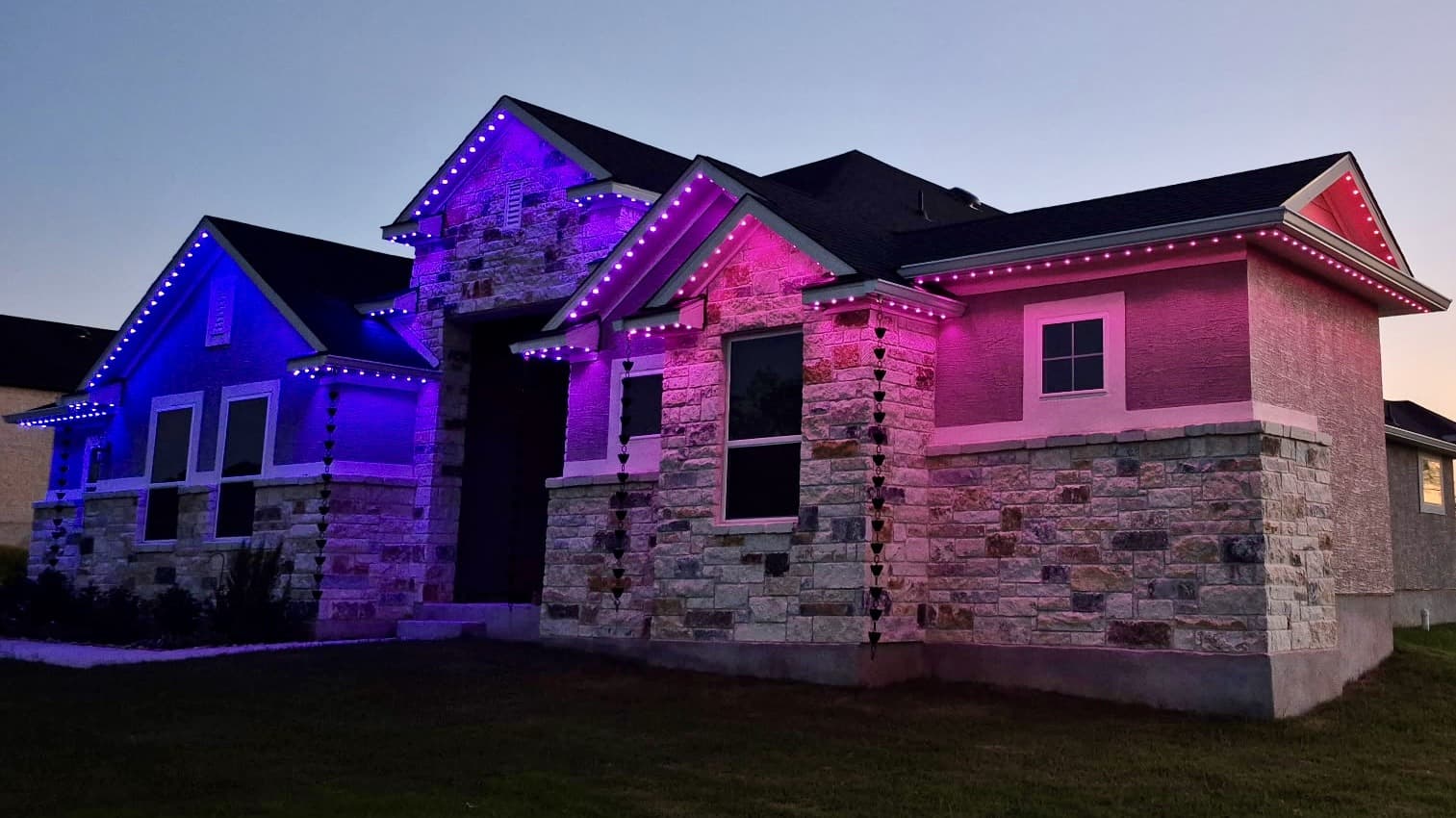 Representative customer-supplied LIT365 installation for the Dallas service market: a facade in a colored permanent-lighting scene