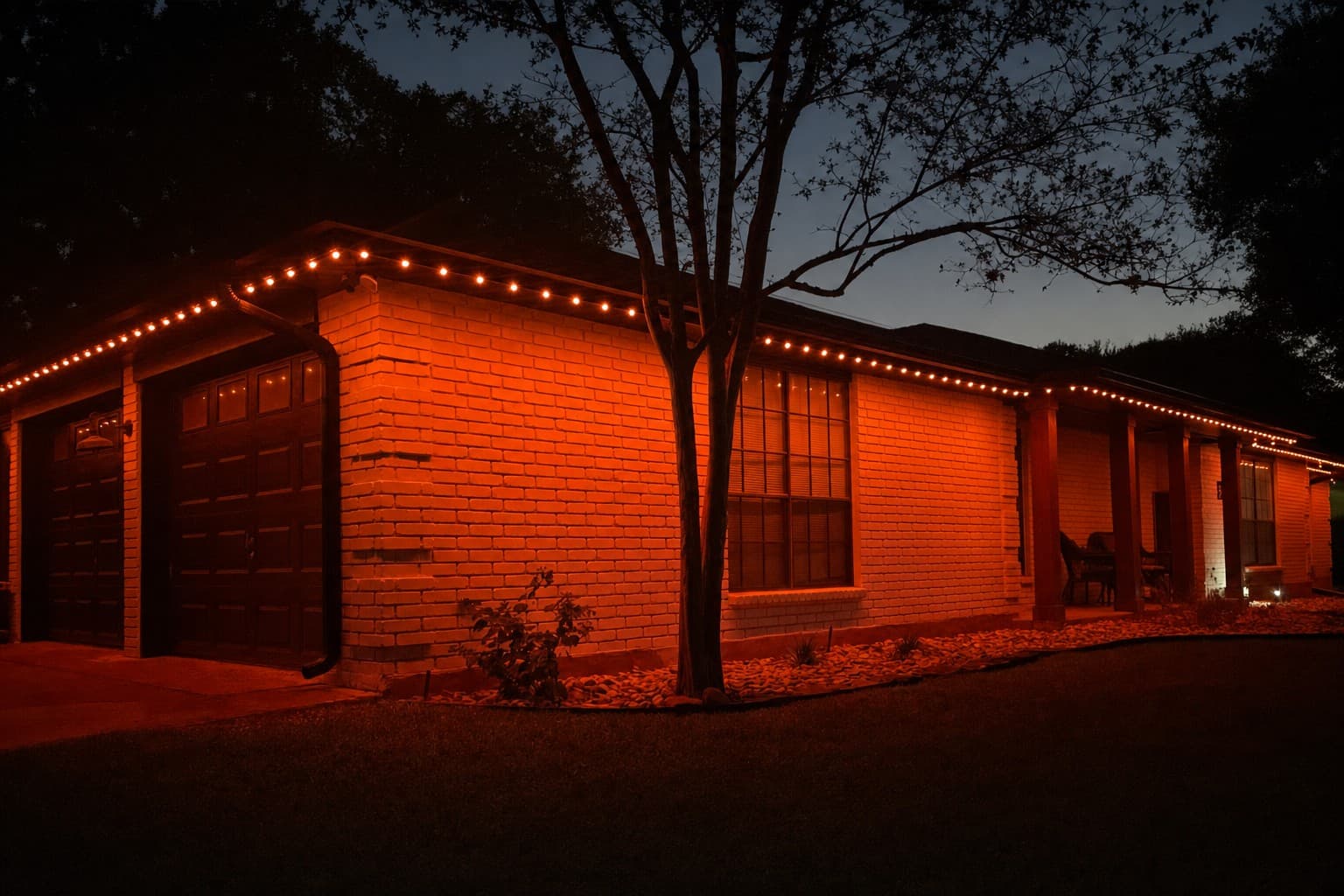 House washed in team-color orange permanent lighting at night